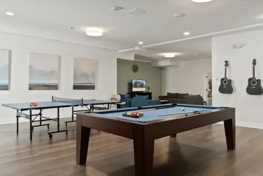 Recreation room with pool table, ping pong table, and lounge area at the Camas facility