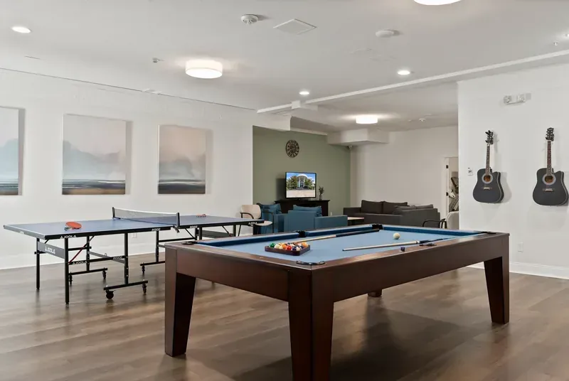 Recreation room with pool table, ping pong table, and lounge area at the Camas facility