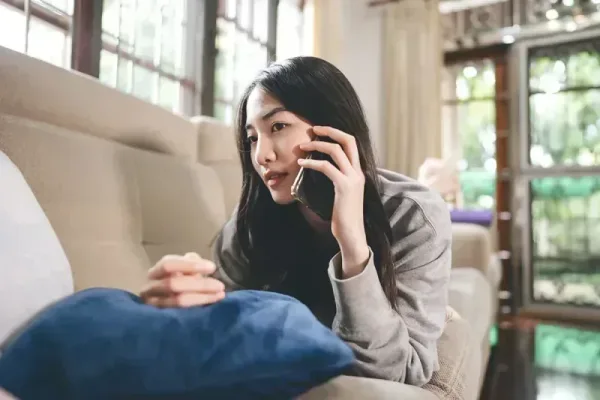 Woman in recovery receiving support through phone call