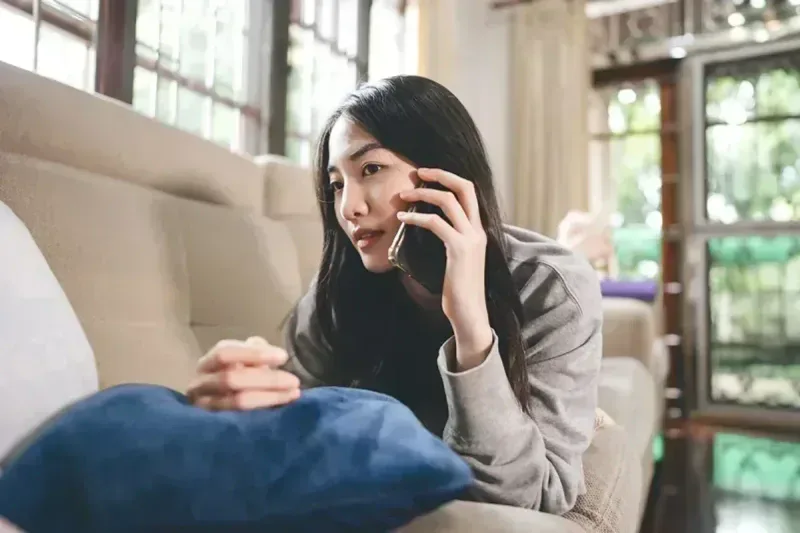 Woman in recovery receiving support through phone call