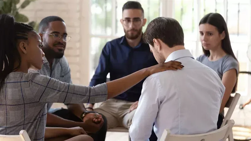 Two people in recovery discussing their treatment journey