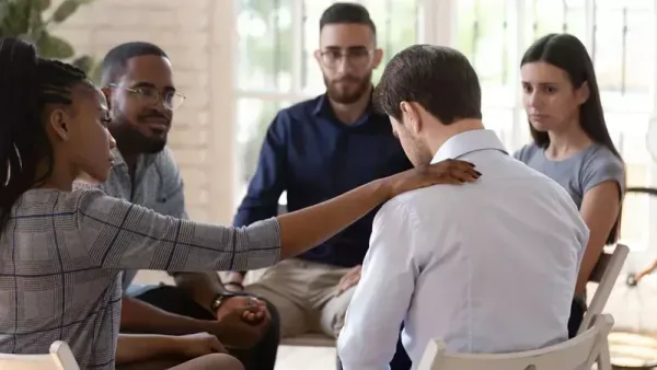 Two people in recovery discussing their treatment journey