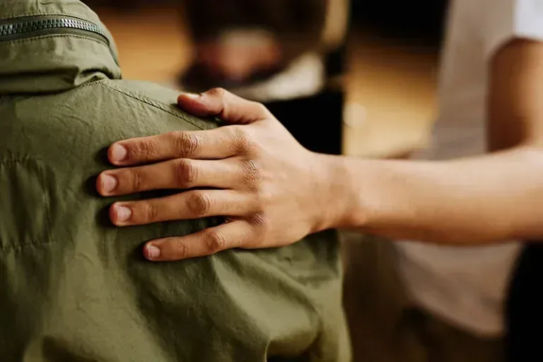 Resident receiving support in sober living community