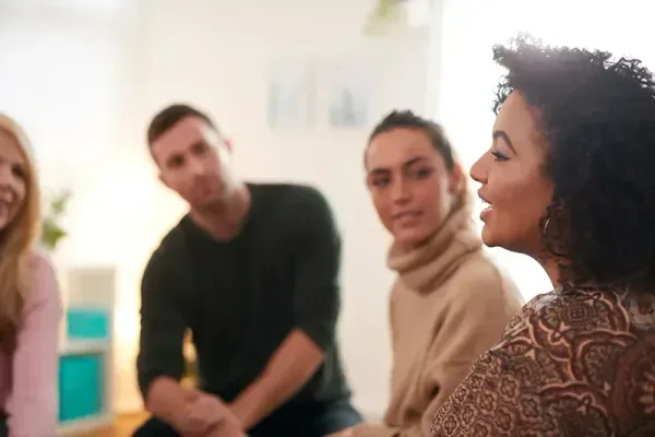Residents in a supportive sober living group conversation