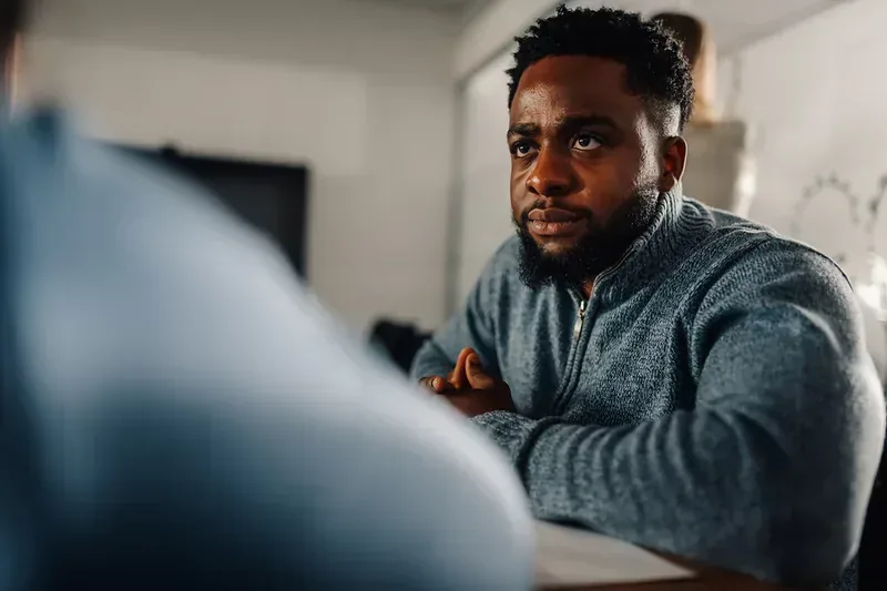 Man speaking during a sober living support conversation