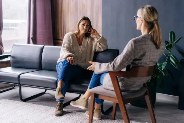 Two people in therapy session during marijuana addiction treatment