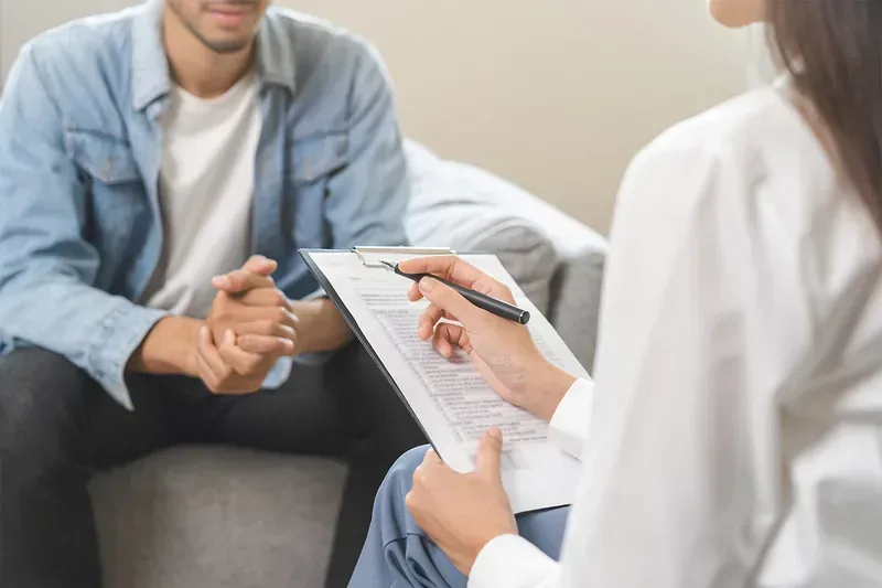a doctor and client talk about medication-assisted treatment