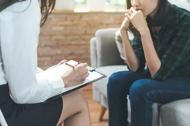 Therapist taking notes during a personality disorder treatment session