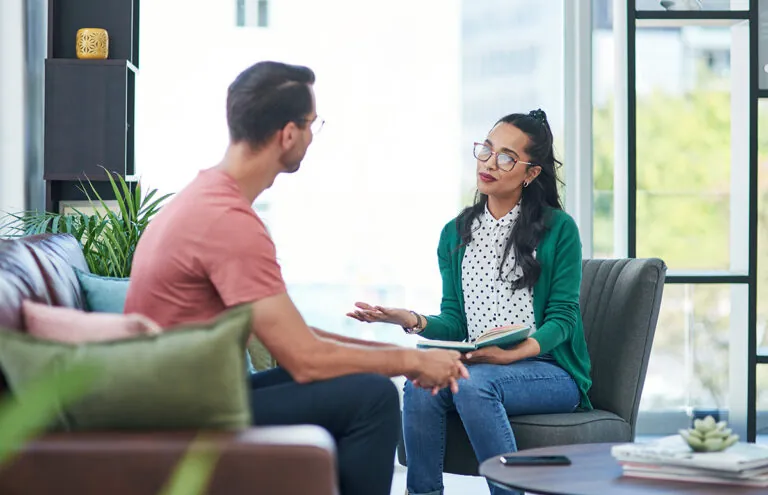 a therapist talks to a participant in a medical detox program