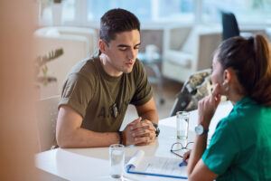 a servicemember talks to a therapist during veteran addiction treatment