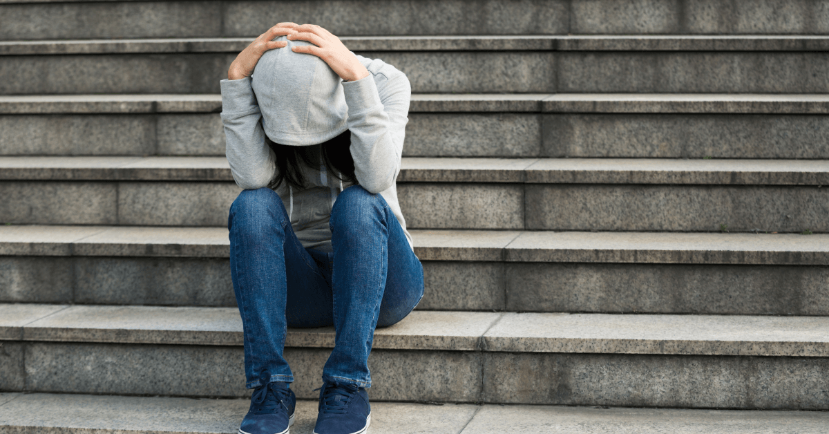 Sad woman sitting on stairs