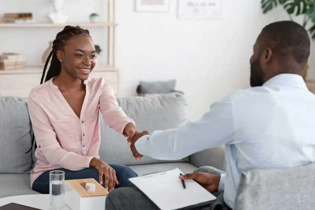 a client shakes hands with a therapist after talking about treating bipolar disorder during rehab